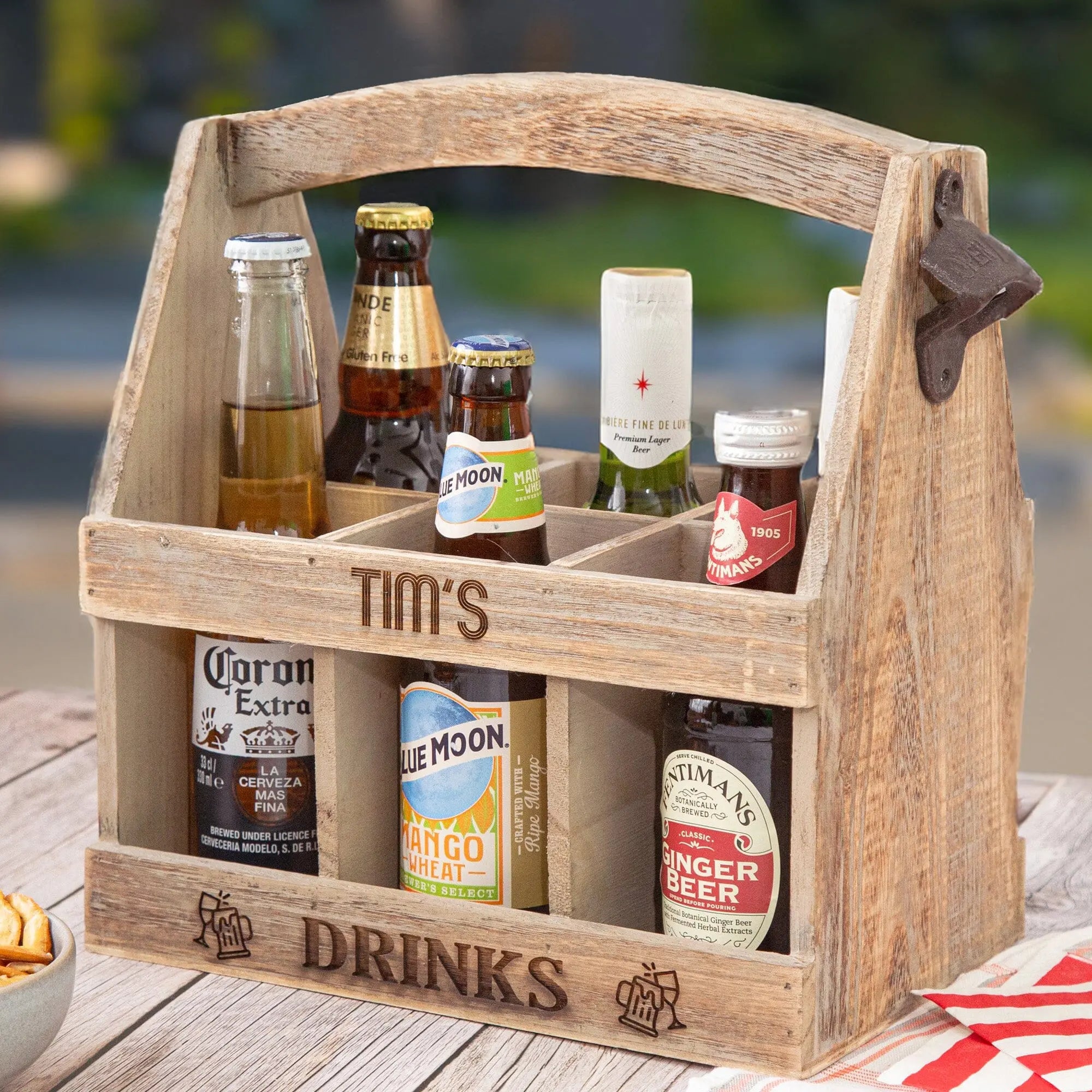 Wooden Bottle Carrier with Bottle Opener, displayed with engraved design and text on a BBQ table