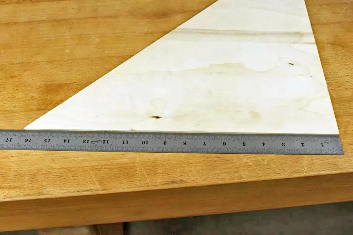 Transfer the measurement to the plywood back and connect the two lines to give the bottom cut for the triangular back.