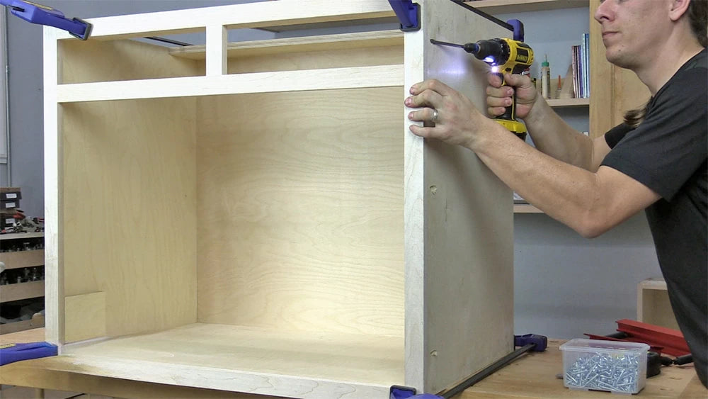 Adding a face frame to a cabinet box covers the plywood edges and provides openings for doors and drawers.