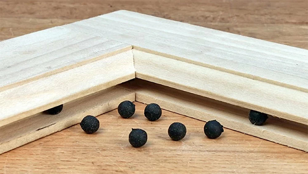 Space balls are small rubber balls that help center a door panel and keep it from rattling in the frame. These are particularly helpful when using door panels made from solid wood. The space balls help accommodate wood movement.