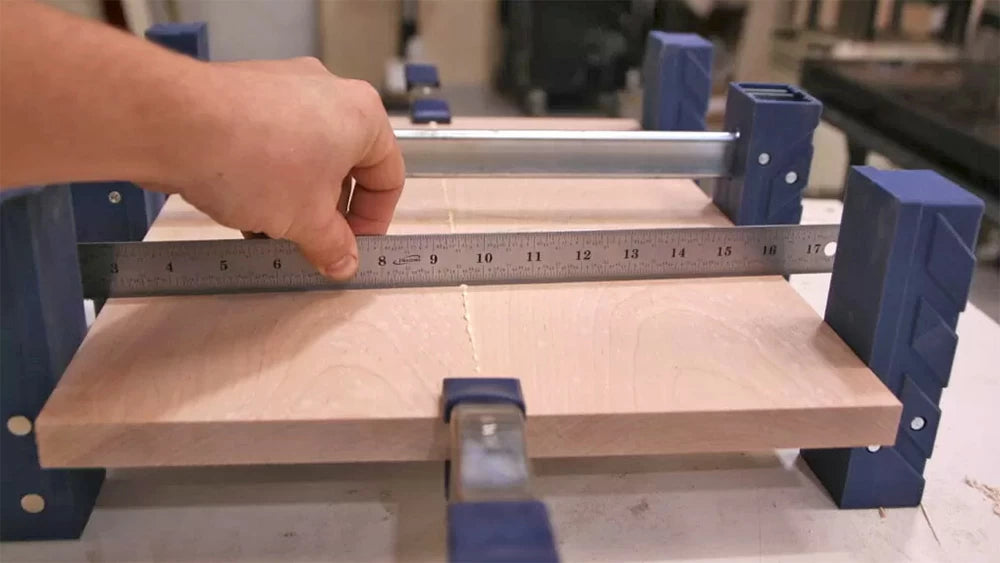 Use a straightedge to ensure the panel remains flat as you apply clamping pressure.