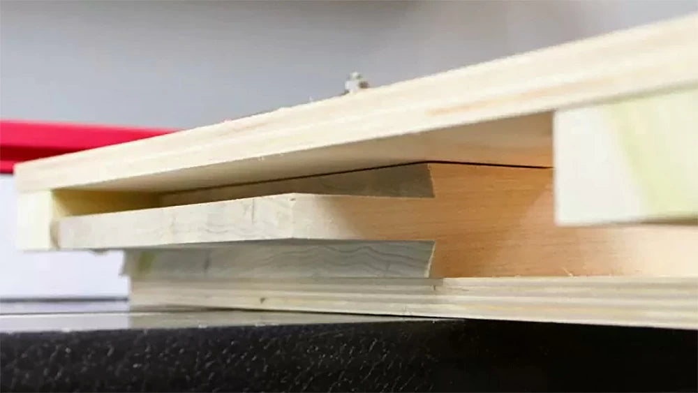 A shop-made coping sled accommodates the wide door rails and holds them secure when routing the extended tenons.