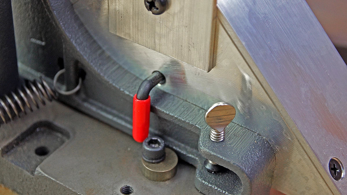 The extension support at the top helps steady the workpiece, while the red clamp slips over the existing fence.Top-Trim Attachment for the miter trimmer . Great for working with picture frames when working from the inside of the rabbet.