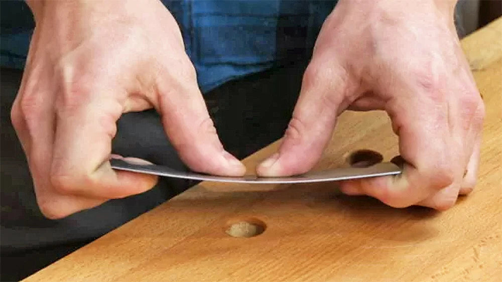 Sharpening a scraper.