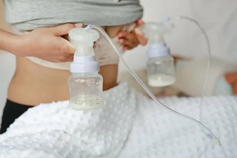 mom using breast pump