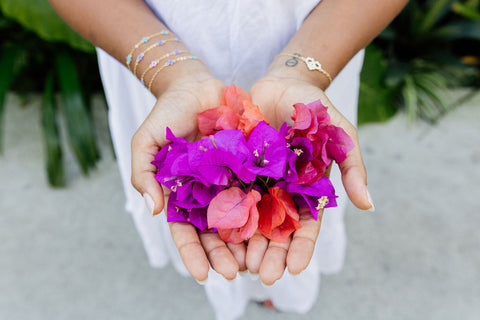 Yasmin's hands full of bougainvillea flowers