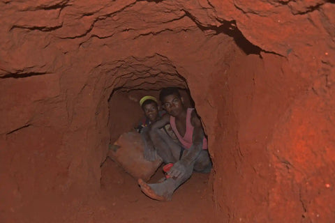 Child tourmaline miners in a dusty hole in Madagascar