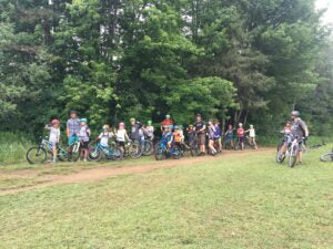 Kids in a clearing along a mountain bike trail