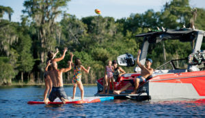 Kids on float beside a boat