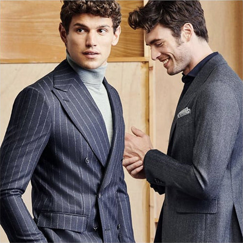 Two young men looking sophisticated and flawless in perfectly fitting custom suits.