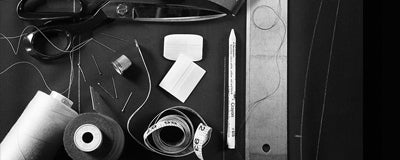 Various luxury threads and other tools of the trade used by our expert tailors to craft precise-fitting menswear.