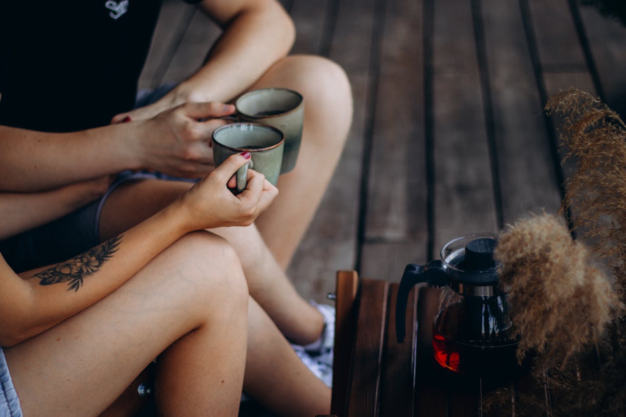 friends with tattoos having a coffee