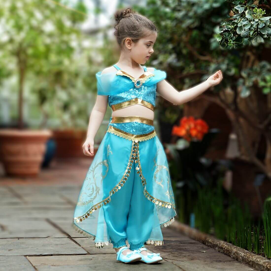 Girl in a two-piece blue Arabian princess costume