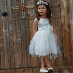 girl in a white and silver dress with a tiara