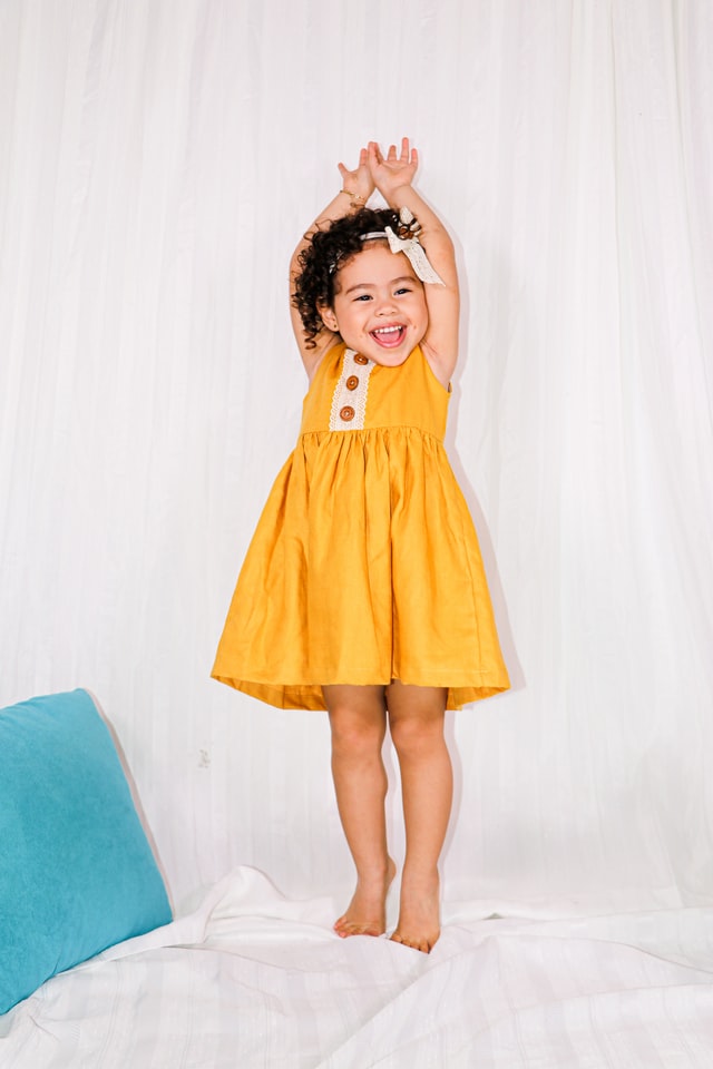 girl smiling in yellow dress