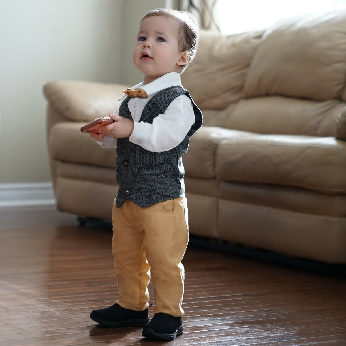 Toddler in brown pants and grey vest