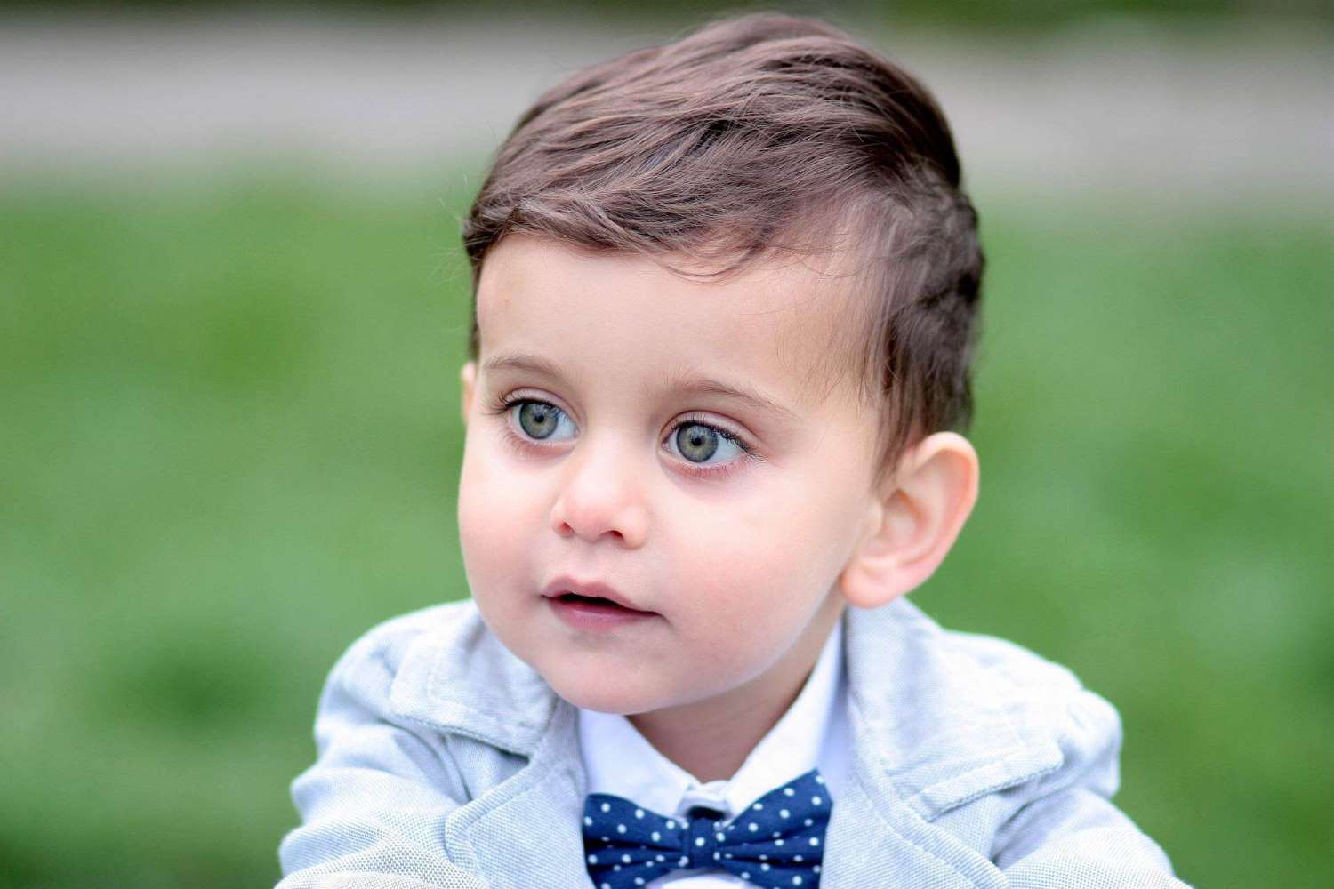 toddler boy in stylish outfit with polka dot bow tie