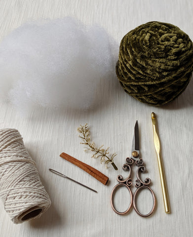 crochet hook, scissors, rope, cinnamon stick, yarn, poly fil, tapestry needle, flower