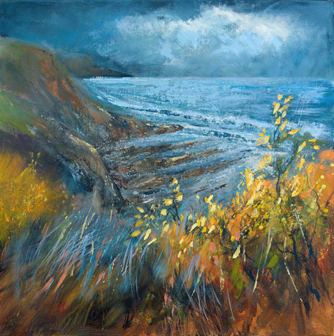 Cornish cove with blue seas and cliffs surrounded by yellow gorse