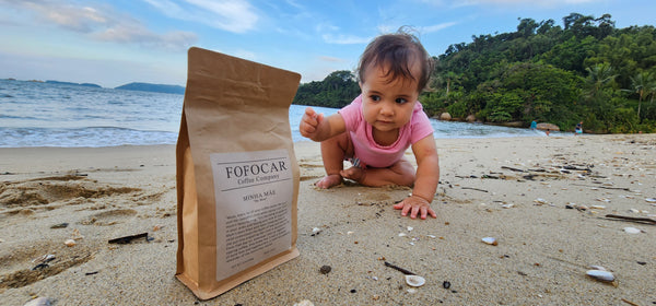 specialty Coffee bag on a beach with a baby