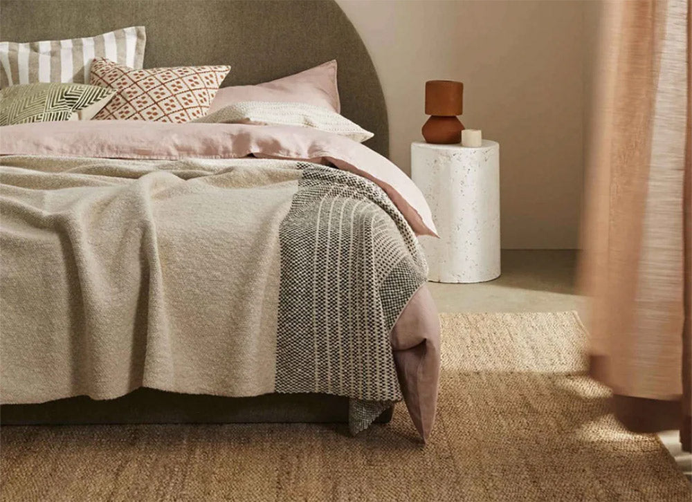 Weave rug in a modern bedroom, placed under a bed
