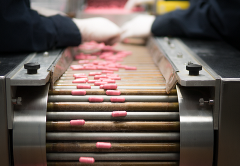 Pink colored capsules getting manufactured