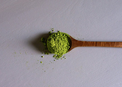 Green powder in a spoon