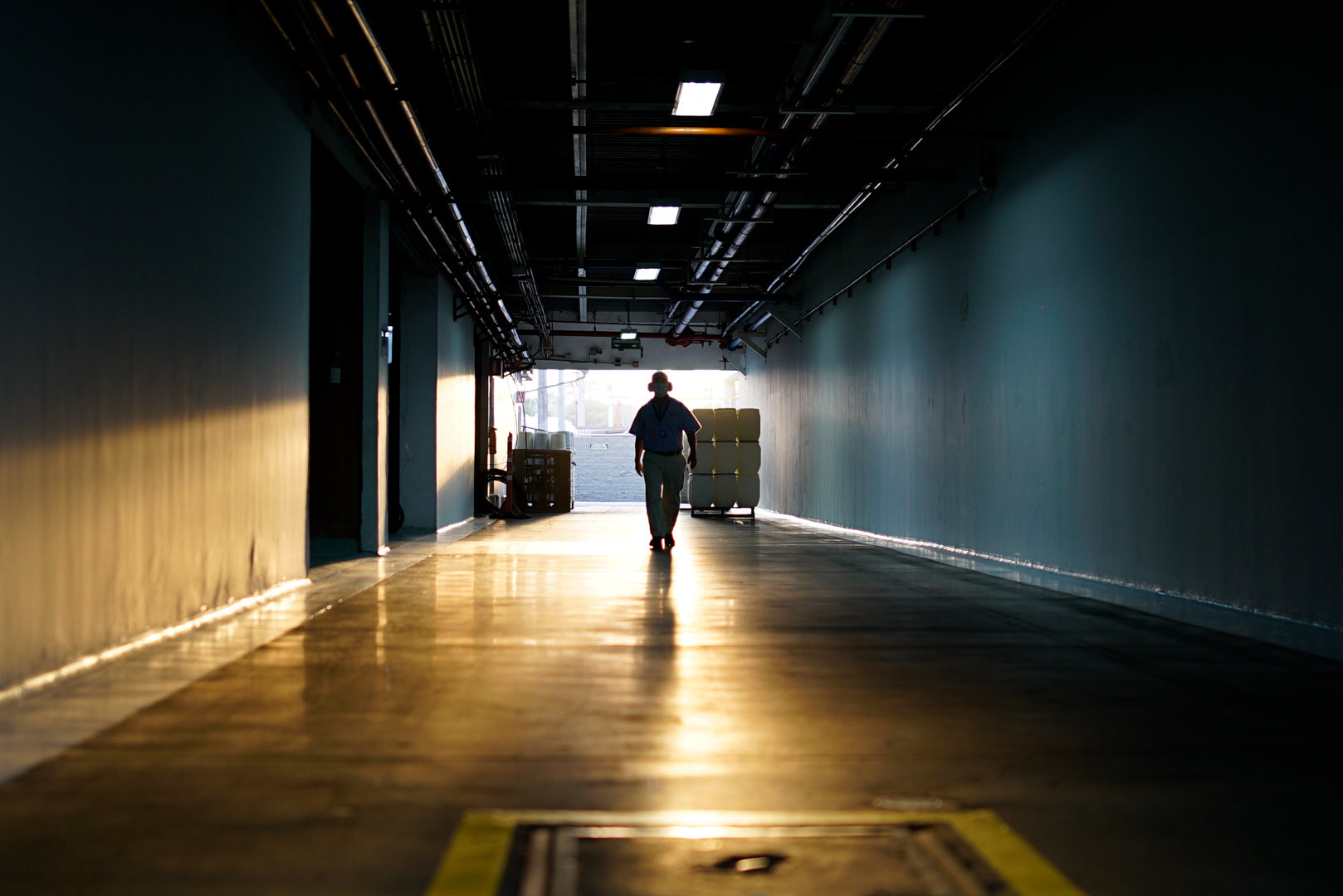 Artistic picture of a man walking confidently toward the camera in one of Colombina's candy production Plants