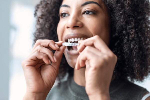  A smiling woman wearing clear aligners