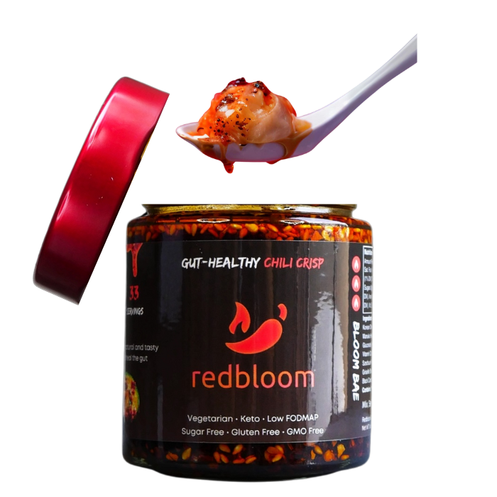 Jar of Redbloom chili crisp with spoonful above it.