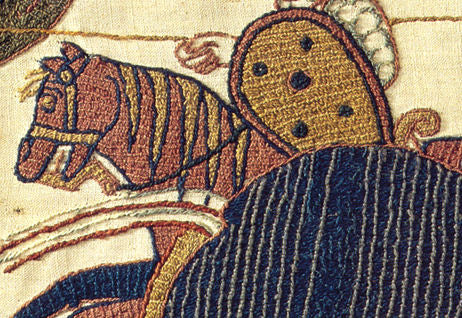 Close-up of hand-embroidered horse detail on the Bayeux Tapestry, showcasing intricate stitching and exquisite craftsmanship