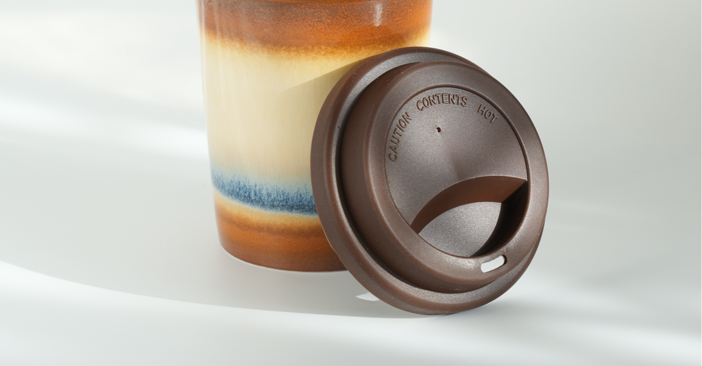 Ceramic travel tumbler with silicone lid