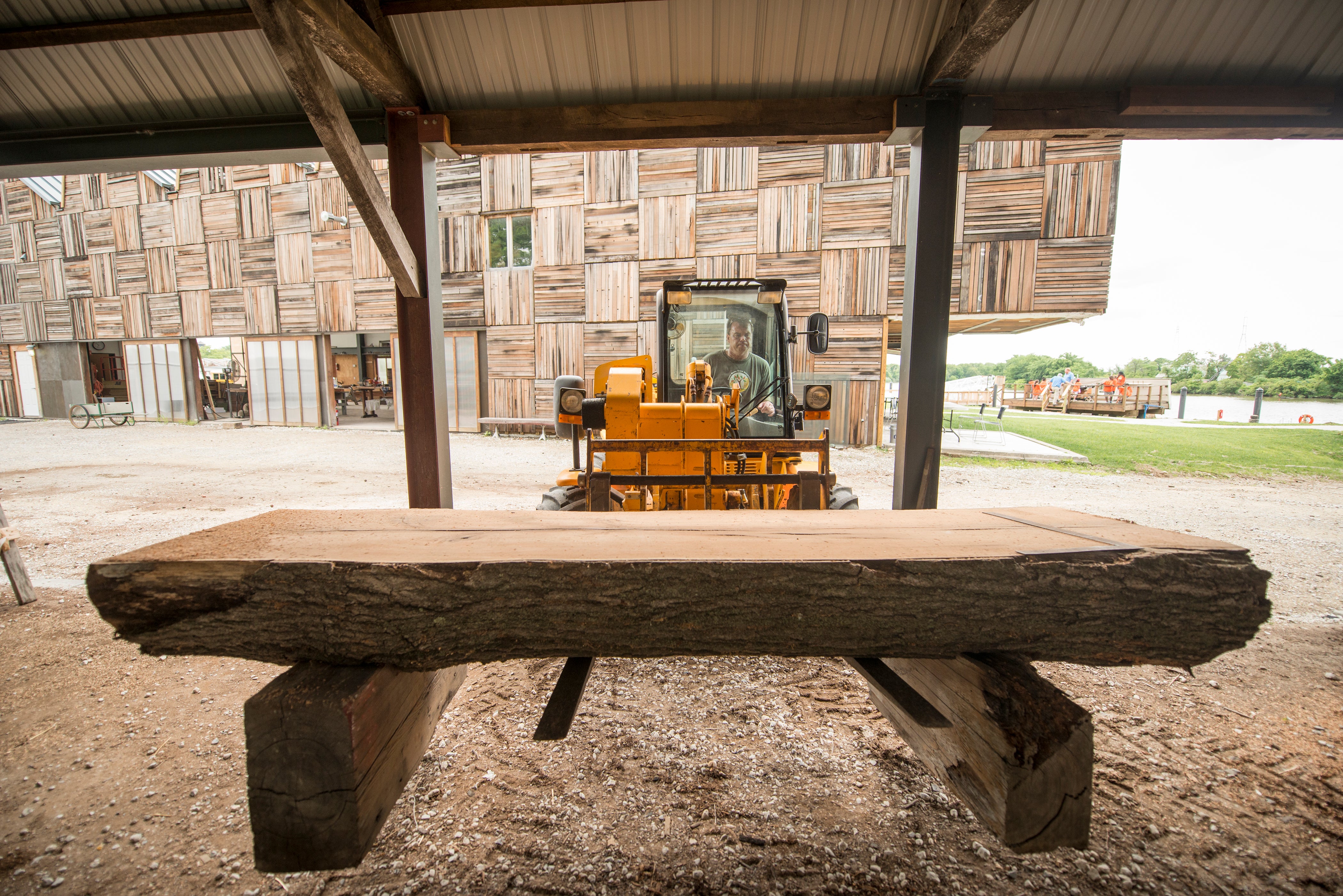 Forklift moving fallen lumber