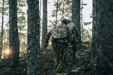 hunters wearing camouflage in the woods