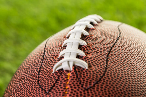 american-football-close-up-green-grass