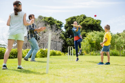 family-playing-cricket-park