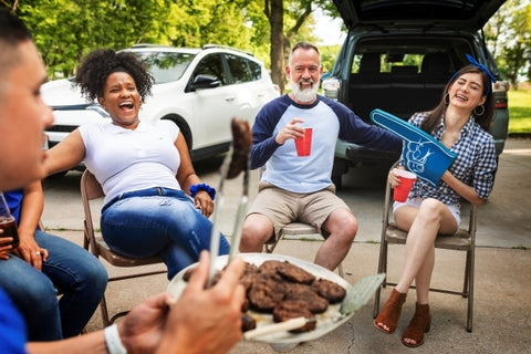 friends-drinking-eating-tailgate-party