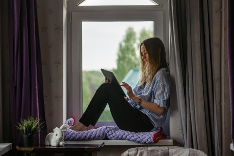 girl-student-sits-windowsill-dorm-room-studies-tablet