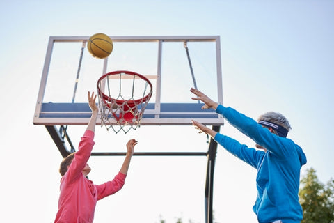 group-young-male-teenagers-colourful-hoodies-playing-basketball