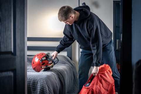 young-man-with-football-helmet-his-room
