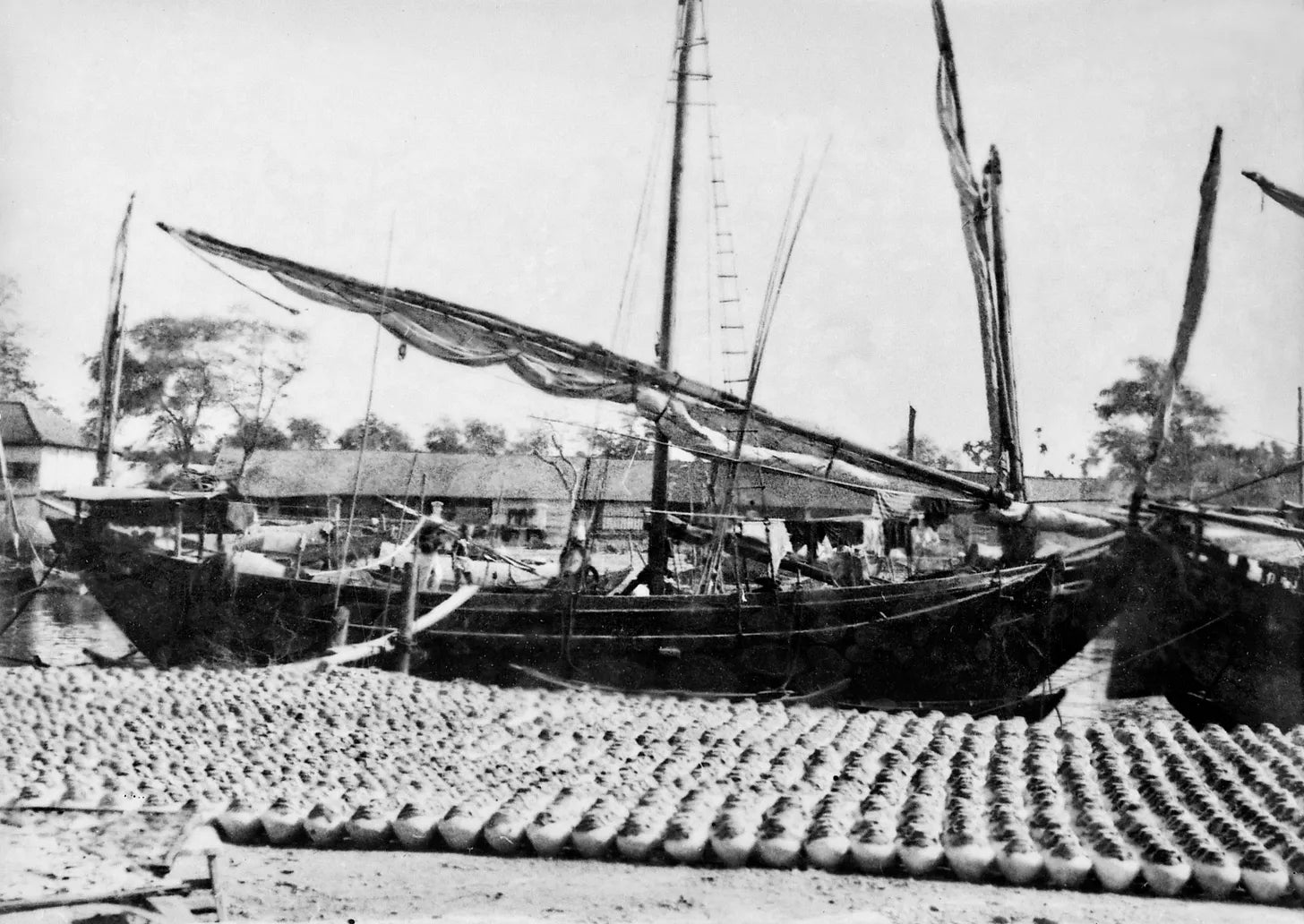 Fish sauce waiting to be loaded onto the boat. Phan Thiết 1920s. Unknown photographer.
