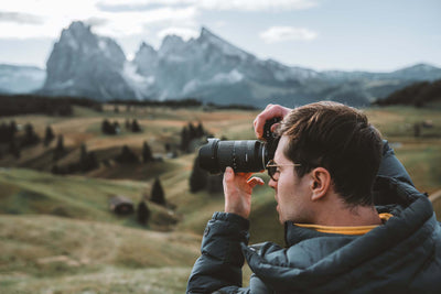 man shooting photos in the highlands