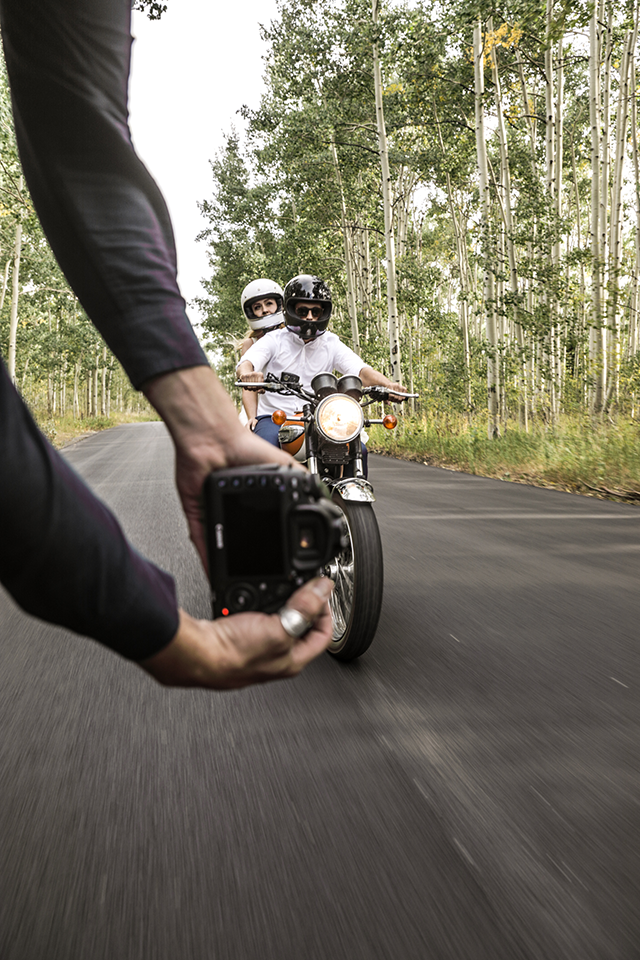 Michael Ori photographing a man and woman on motorcycle 