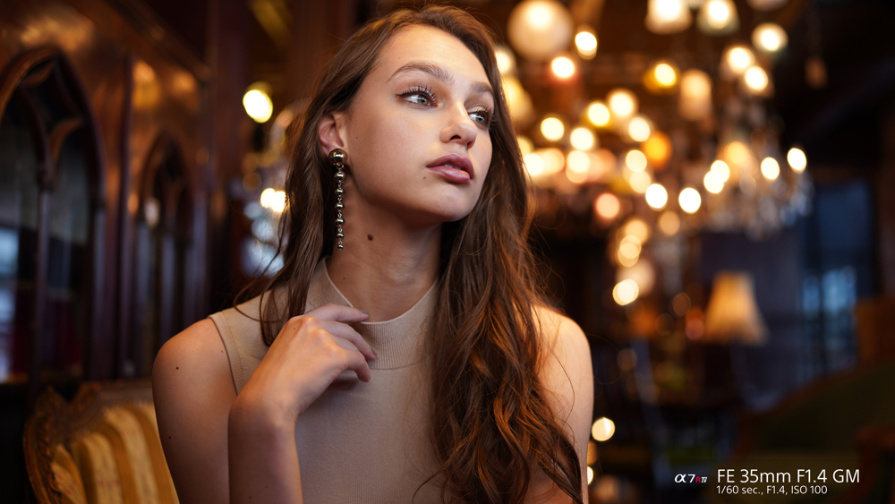 Model sitting under moody lighting taken with the FE 35mm F1.4 GM lens