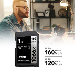 man working at desk with lexar sd card in foreground