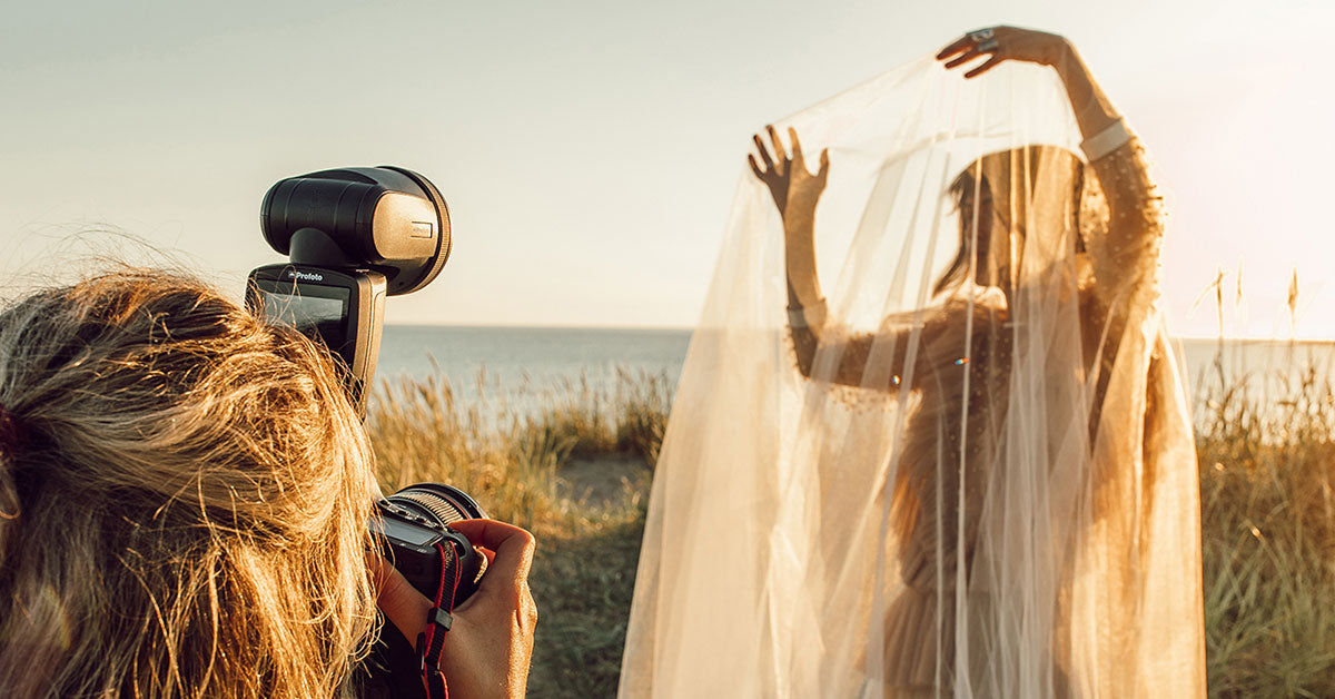 photographer using the Profoto A10 flash to light model