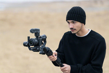 Videographer with Sony APS-C 15mm lens on Camera and gimbal