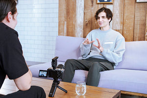 man being interviewed while sitting on a couch