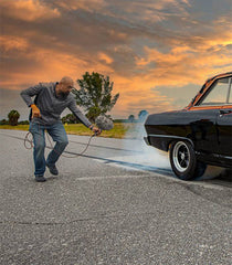 man recording car burnout