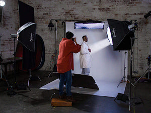 Photographer shooting model on background using 6090 light boxes